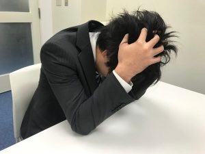 頭を抱える男性